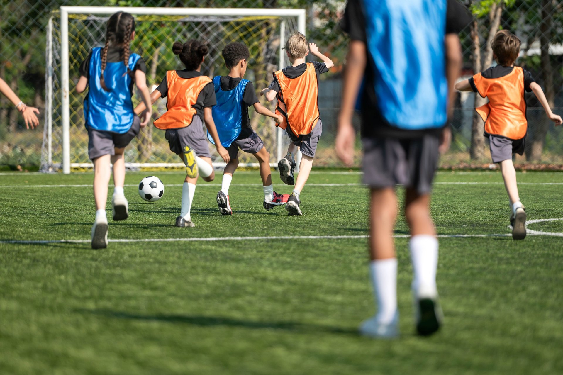 Kids playing soccer together